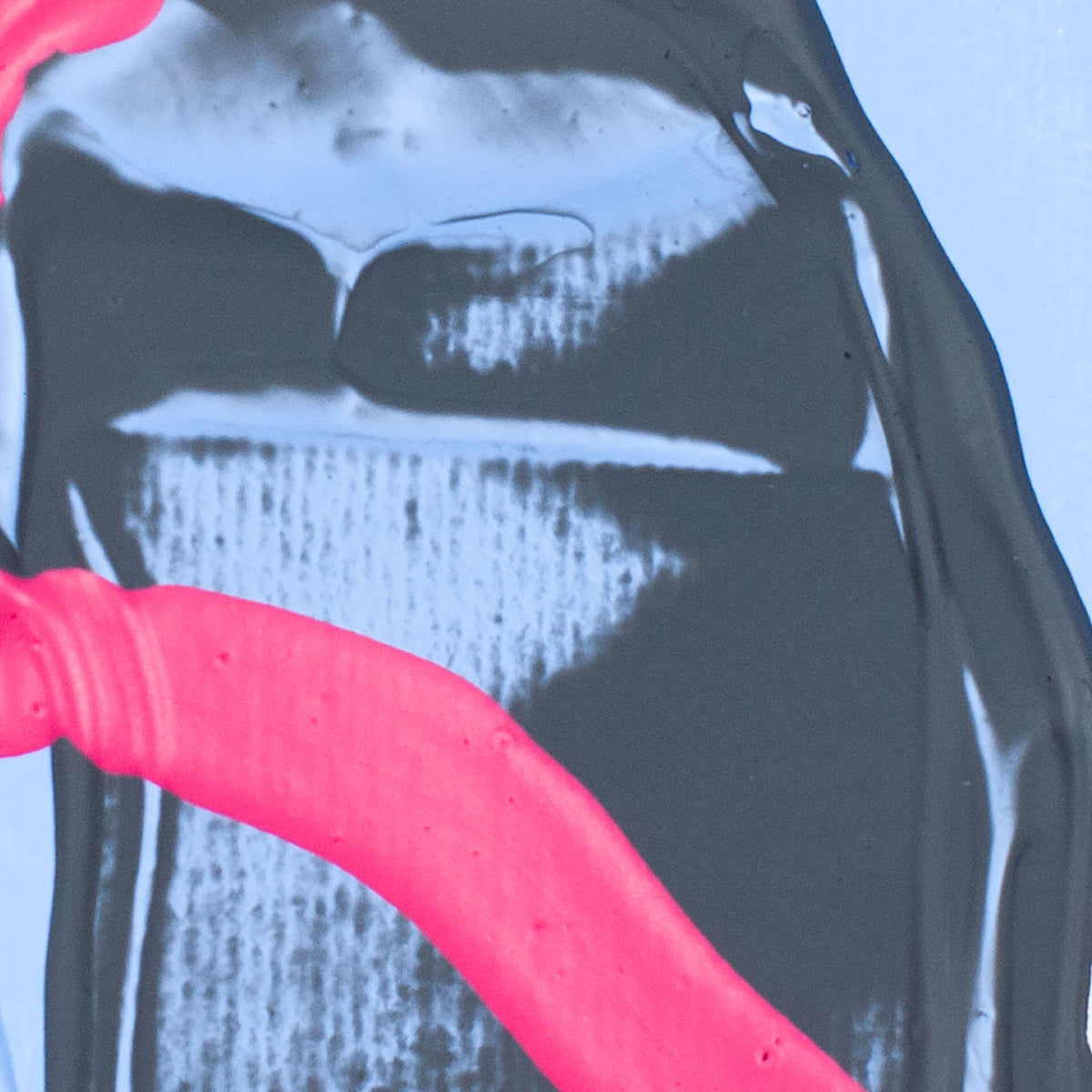 A close-up of a glossy black bottle or container with a bright pink curved section and a pale blue translucent background visible around it.