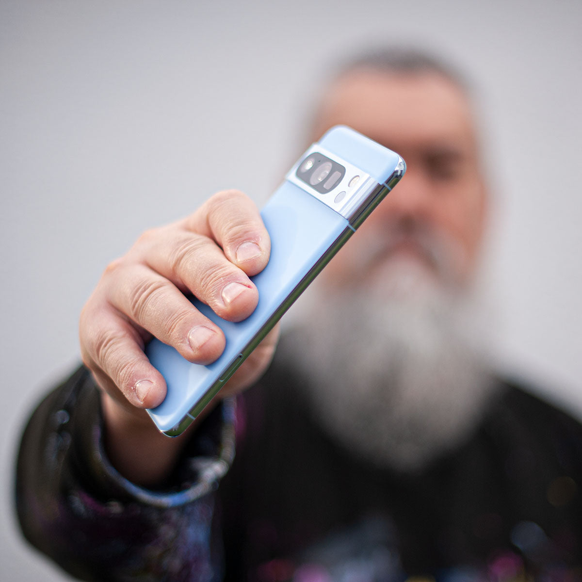 Abstract painter holding a smartphone, offering direct contact
