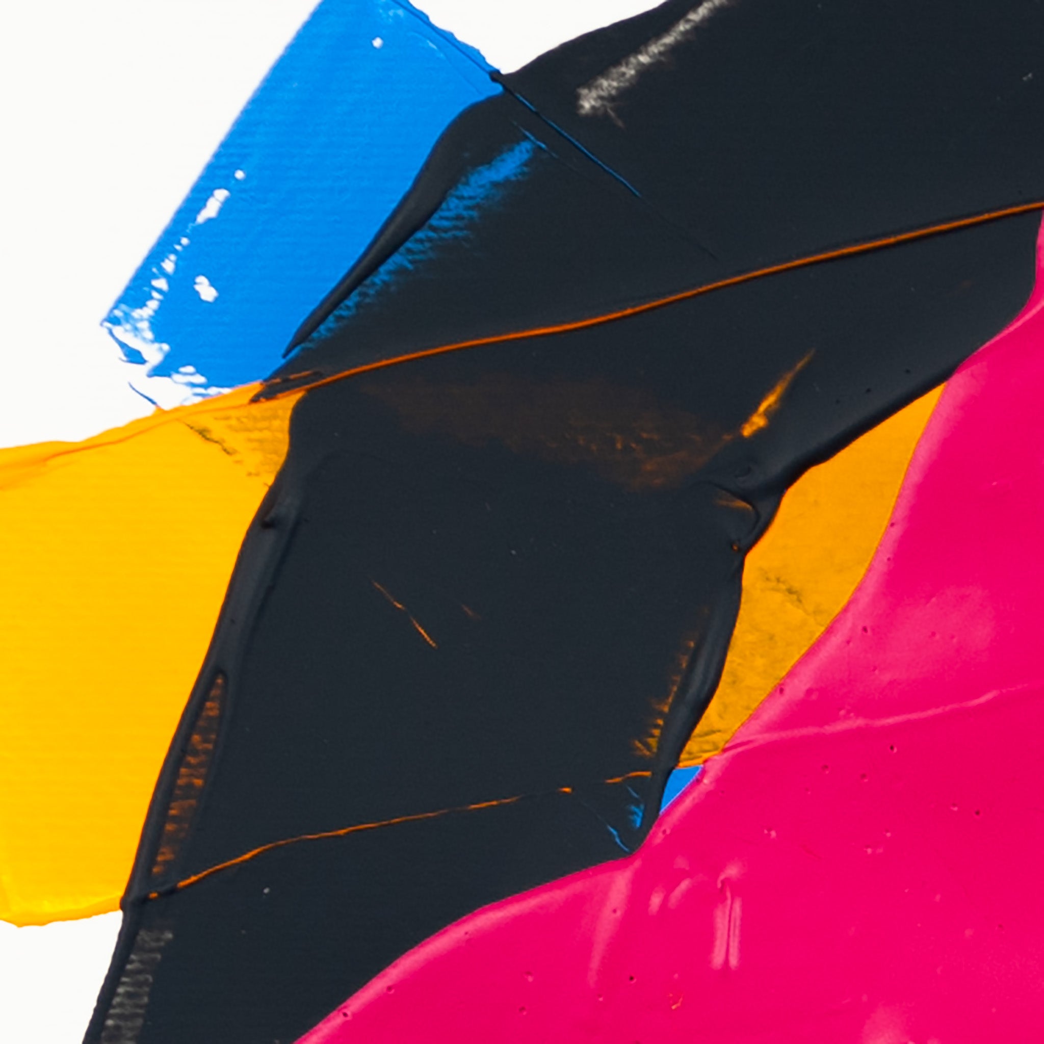Close-up of dark grey textured acrylic paint intersecting matte pink forms with yellow and blue sections on white paper.