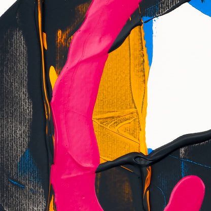 Close-up of matte pink acrylic paint intersecting dark grey textured forms with yellow and blue sections on white paper.