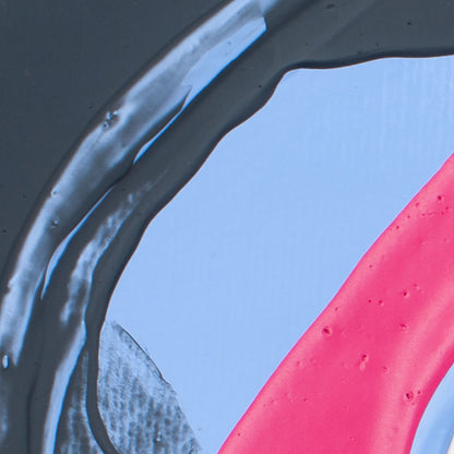Abstract close-up of glossy translucent dark gray material curving over a pale blue surface, with a bright pink curved shape in the lower right.
