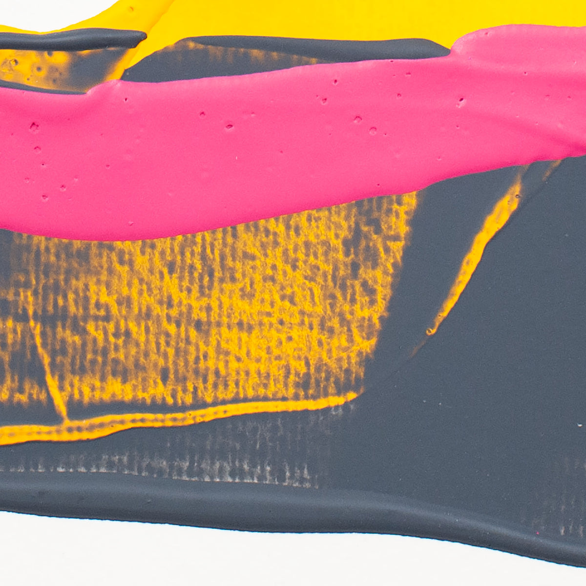 Abstract paint swatch showing thick brushstrokes of hot pink, metallic gold, and dark charcoal gray on a white background.