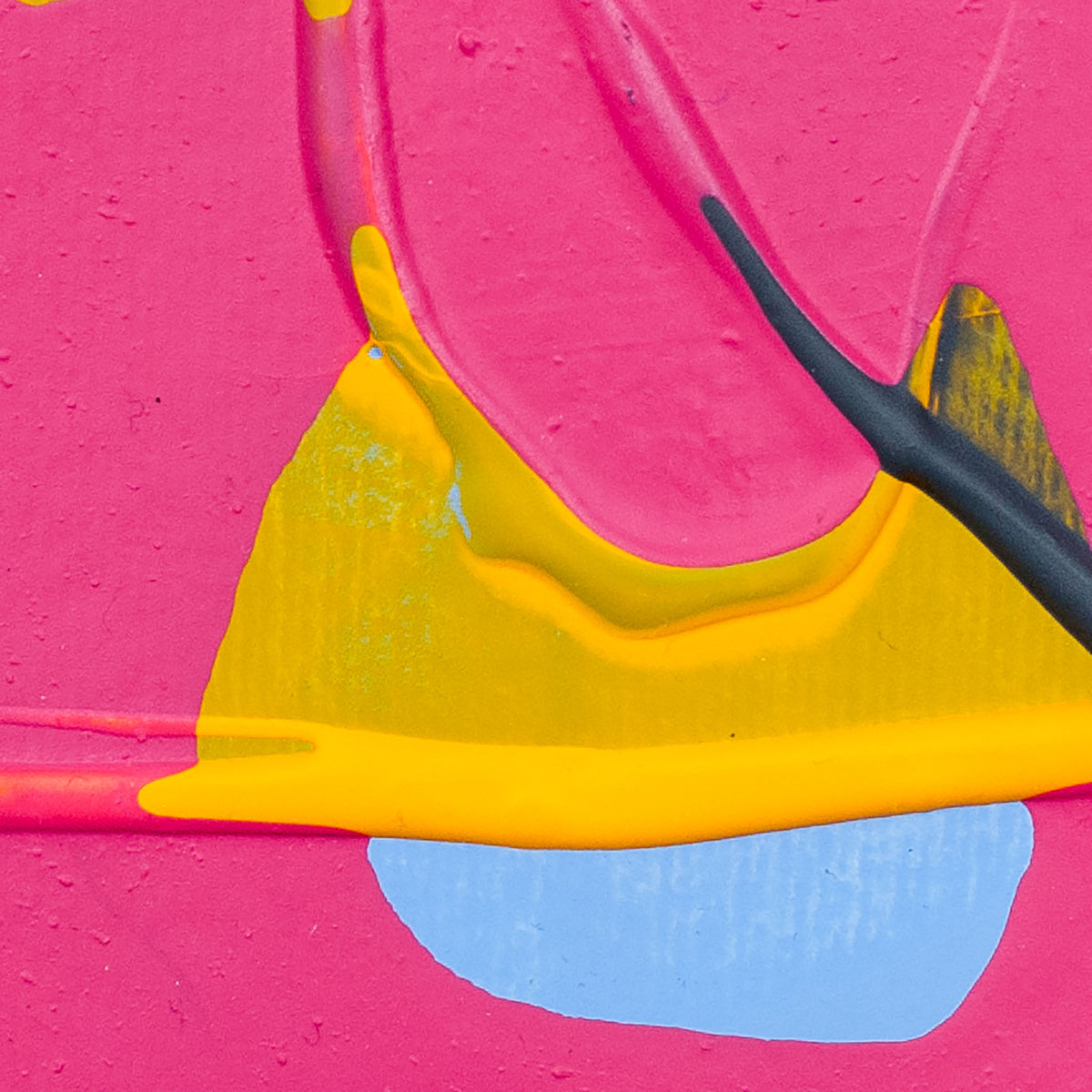 Close-up of a bright pink textured surface with bold yellow paint, a light blue shape, and a black paintbrush applying paint.