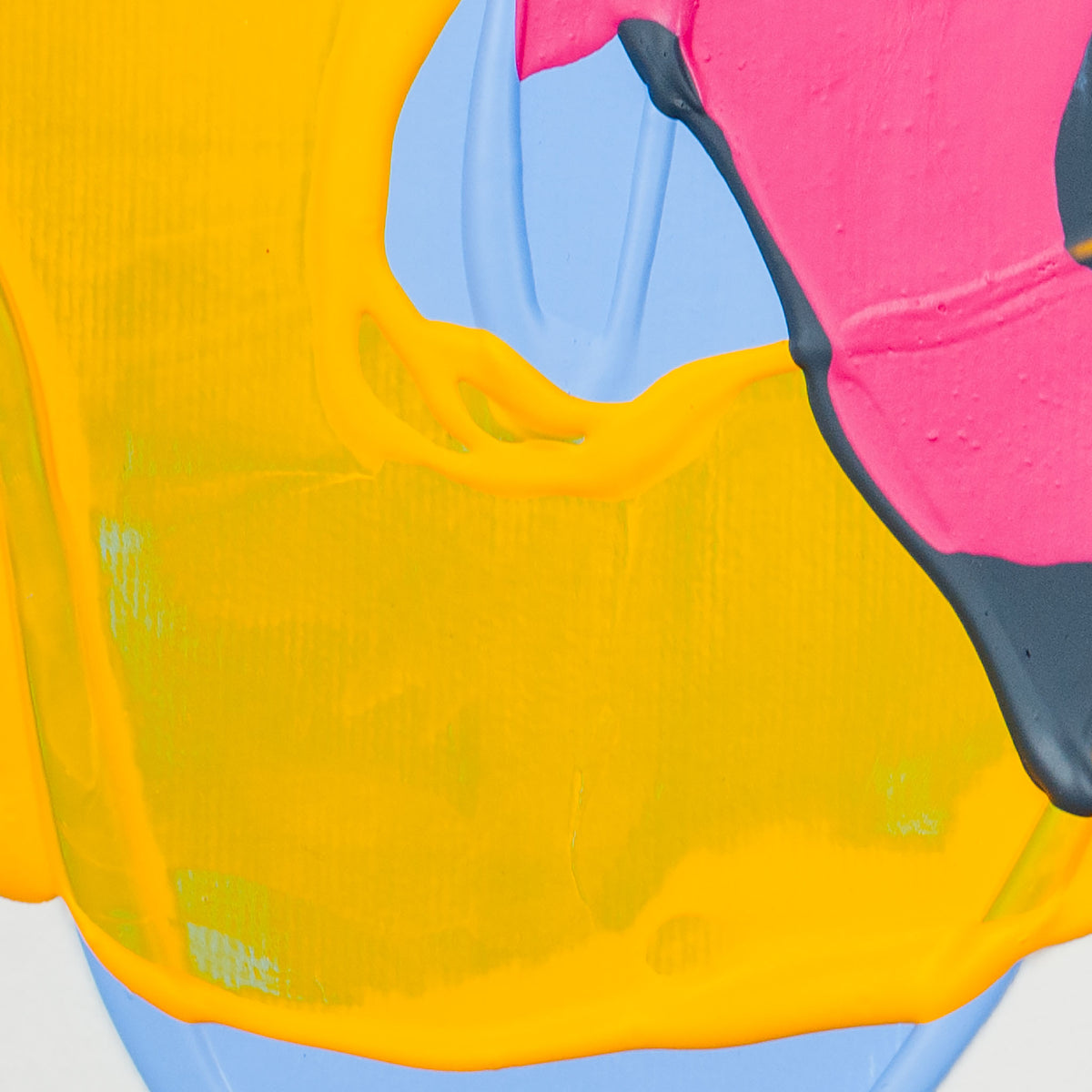 Abstract close-up of a colorful surface with a large bright yellow area, a pink section, light blue sections, and dark charcoal edges.